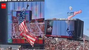 Terrifying moment skydiver hits scoreboard at Virginia Tech spring game after strong wind pushes parachute off landing path. International Sports News