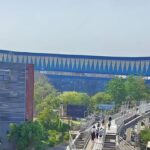 No roof & travelator, commuters avoid footbridge linking rapid rail, Red Line amid rising heat. Noida News